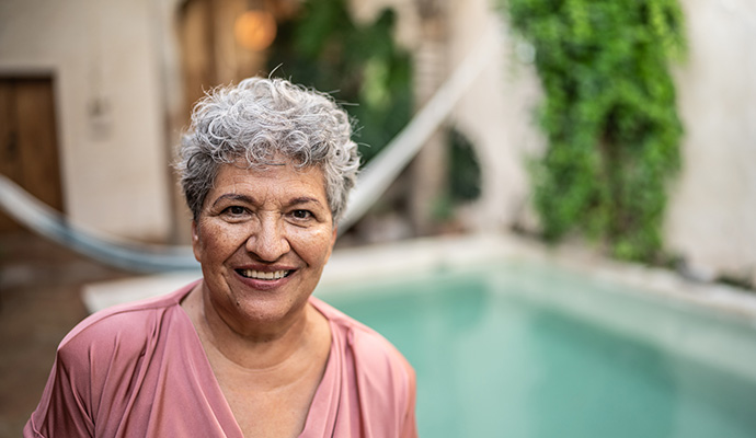 woman standing in front of villa and pool